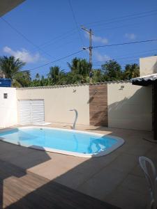 a swimming pool in the backyard of a house at Casa Jacuipe temporada in Camaçari