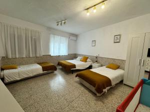 a room with three beds in a room at Casa de pueblo cerca de Gredos y Navaluenga in Navalmoral