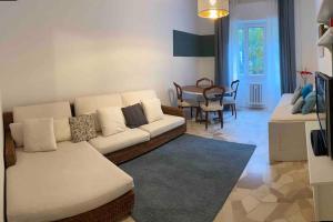 a living room with a white couch and a table at Intero appartamento Rho Centro in Rho