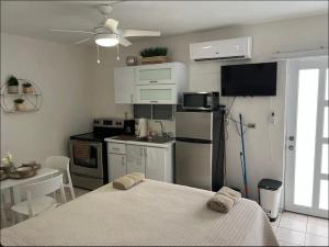 a kitchen with a table and a bed in a room at Shalex House 4 in Campamento Pinones