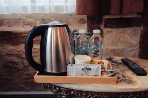 a coffee pot on a tray with bottles of water at konak esila in Uşak