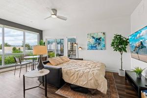 a bedroom with a bed and a living room with a table at Gorgeous Central City 2BD 2BA in Salt Lake City