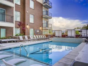 a swimming pool with chairs and a building at Gorgeous Central City 2BD 2BA in Salt Lake City