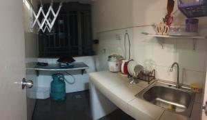 a small kitchen with a sink and a counter at Santai Homestay 2 in Kota Kinabalu