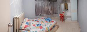 a bedroom with a bed and a red chair at Santai Homestay 2 in Kota Kinabalu