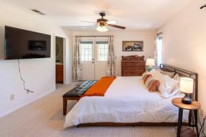 a bedroom with a bed and a ceiling fan at Stylish Country Cowboy Home with Hot Tub on 20 Acres in Borrego Springs
