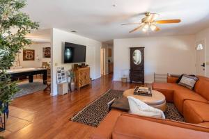 a living room with a couch and a table at Stylish Country Cowboy Home with Hot Tub on 20 Acres in Borrego Springs +51 photos