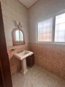 a bathroom with a sink and a mirror and a window at Casa con alberca de Don Vico in Yautepec de Zaragoza +13 photos