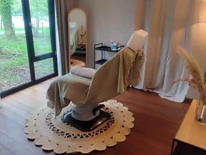 a statue of a woman sitting in a room at Bungalow Near Forest & Lake in Antoing