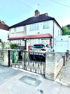 a car parked in front of a house at Stunning Modern Cozy 5 star 3 bedroom house-Free Parking Greater London Metro Stations hosted by Tony in Catford