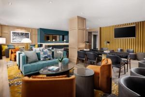 a living room with couches and tables and chairs at Residence Inn by Marriott New York Downtown Manhattan/World Trade Center Area in New York