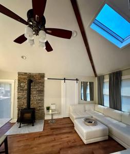 a living room with a couch and a ceiling fan at Lovely private home in a serene neighborhood in Totowa
