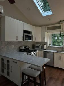 a kitchen with a counter top and a window at Lovely private home in a serene neighborhood in Totowa