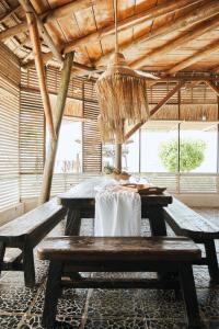 a picnic table in a building with a chandelier at El Embrujo Tintipan in Tintipan Island