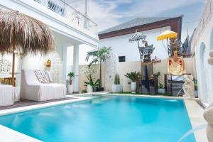 a swimming pool in the backyard of a house at Tirta Mumbul Villa in Badung