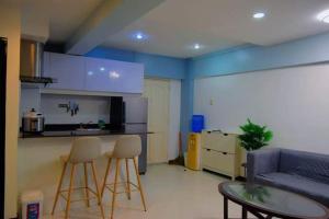 a living room with a couch and a table and chairs at The Loft Nook - 2 bedrooms only in Pusok
