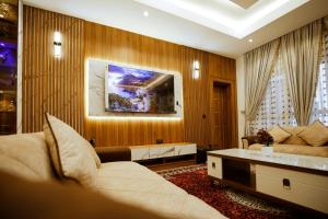 a living room with a couch and a table at Elite Luxury 3-bedroom Apartment in Abuja in Abuja