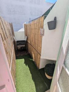 a view of a balcony with a bench and grass at Centro Cidade Holiday in Portimão