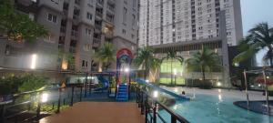 a swimming pool with a slide in a building at Royal Deluxe & Private Apartments - West Jakarta in Jakarta
