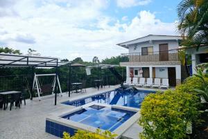 a swimming pool in front of a house at Finca Hotel VILLA SOFIA in Montenegro