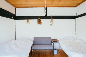 Postel nebo postele na pokoji v ubytování hinatabocco guesthouse