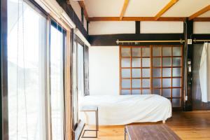 Postel nebo postele na pokoji v ubytování hinatabocco guesthouse