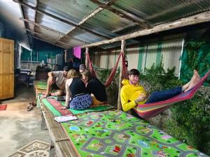 a group of people sitting in hammocks at Sunny in town hostel in Pai +19 photos