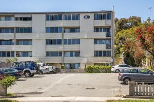 a parking lot in front of a building at Ocean Breezes in Fremantle