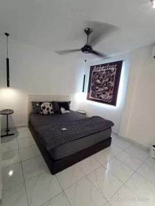a black bed in a room with a ceiling fan at Amberhouse 1 in Semporna +6 photos
