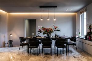 a dining room with a black table and chairs at Angelroad Hotel in Tonosho