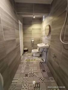 a bathroom with a sink and a toilet at Amberhouse 1 in Semporna