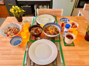 een tafel met borden en kommen met eten erop bij Entire Home with King Bed in Chiang Mai +8 foto's
