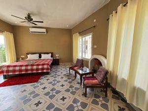 a bedroom with a bed and a fireplace at Rustic Roots Farm Stay in Atāri +41 photos