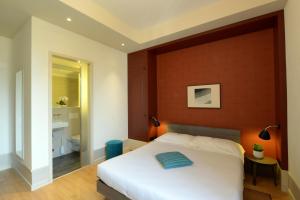 Voodi või voodid majutusasutuse Hotel Pestalozzi Lugano toas