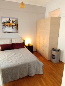 a bedroom with a bed and a painting on the wall at Thissio Hideaway Suite in Athens