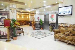 a lobby with furniture and a flat screen tv at Nada Al Deafah Hotel in Mecca