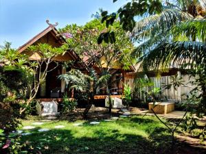 a house in the middle of a garden at Gili Moonlight bungalows in Gili Islands