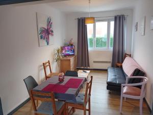 a living room with a table and a couch at THALASSA in Audresselles