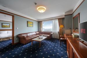 a hotel room with a couch and a table at A25 Signature Hotel in Hanoi
