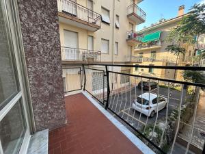 a balcony with a car parked in a parking lot at Casa Alessandra in Alassio