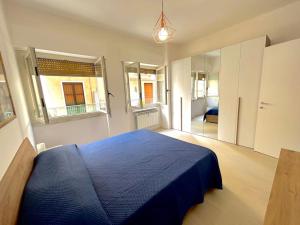 a bedroom with a blue bed in a room at Casa Alessandra in Alassio