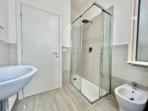 a bathroom with a glass shower and a white sink at Casa Alessandra in Alassio +13 photos