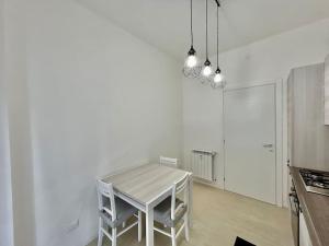 a kitchen with a table and chairs in a room at Casa Alessandra in Alassio