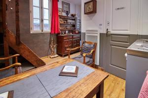 a kitchen with a table with a book on it at La Plus Petite Maison De France in Bayeux +2 photos
