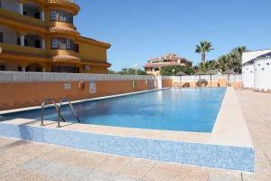 a swimming pool in front of a building at Wohnung in Cartagena mit Gemeinschafts Pool und Terrasse in Los Urrutias