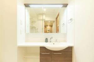 a bathroom with a sink and a mirror at Gran Grace by Tranova in Tokyo +27 photos