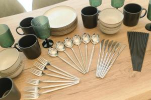 a table topped with plates and forks and cups at Gran Grace by Tranova in Tokyo