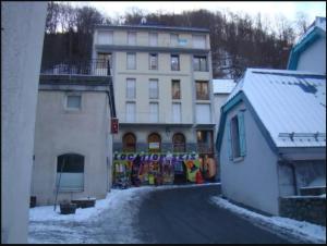 a building with a mural on the side of a street at Appartement au centre de Barèges in Barèges