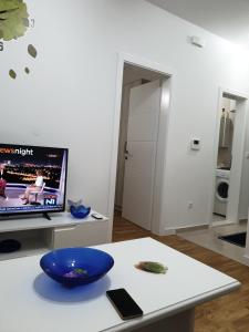 a living room with a table with a blue bowl on it at Apartman Noah in Čapljina