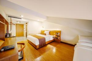 Postel nebo postele na pokoji v ubytování Cosy Feeling Hotel - Beijing Headquarters Xinfadi